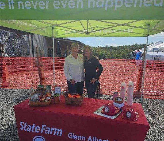 Marketing rep and State Farm rep at an event. 